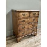 A reproduction walnut and yew miniature chest of two short drawers above three long drawers with