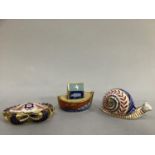 Royal Crown Derby paperweight in the form of a snail together with a Royal Crown Derby paperweight