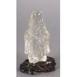 A Chinese rock crystal figure of Lohan, 10.5cm high with hardwood stand