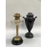 A 19th century oil lamp by Young's Special with glass reservoir of wrythen form supported on brass