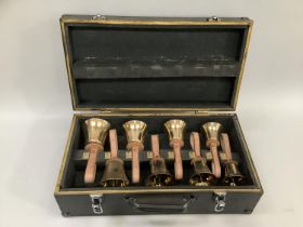 Set of eight musical handbells in fitted case with leather straps