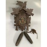 Carved cuckoo clock with weights