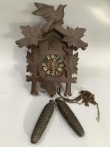 Carved cuckoo clock with weights