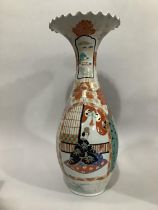 A 20th century Chinese vase with flared frilled rim, painted with cartouches containing figures