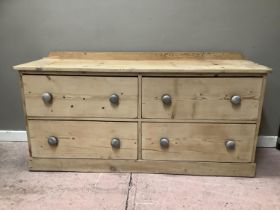 A pine sideboard with four long drawers on pediment base, 154cm wide