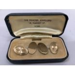 A pair of cufflinks in 9ct gold, with one oval face sun burst bright cut joined by trace links to