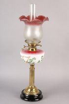 A Victorian brass oil lamp, the pink tinted glass reservoir painted with Gaelic harp and shamrock,