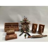 Carved cuckoo clock, a pair of carved indigenous book ends, two carved boxes inlaid with mother of