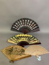 Four Oriental fans: the first a Japanese brisé, wood with polished guards and shaped sticks,
