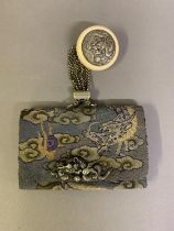 A fine and interesting Japanese needlework Japanese tobacco pouch or purse, with chain and Manju