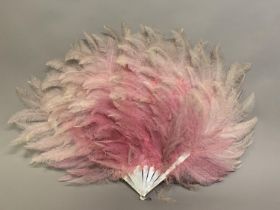 A scarce and large soft pink Rhea feather fan, the monture of white mother of pearl, the pink