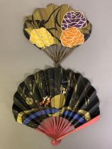 Two Art Deco paper advertising fans, the first with stylized flowers, advertising on the verso the