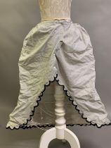 A wired bustle back 1880’sfull-length cotton part-petticoat, white with narrow black stripe,