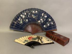 A fan or glove box lacquered in a wine shade, the lid and sides decorated with Japanese fans and