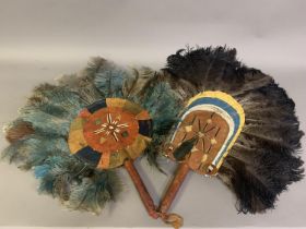 A pair of very large fixed fans, America Indian, feathers mounted on leather, both with designs