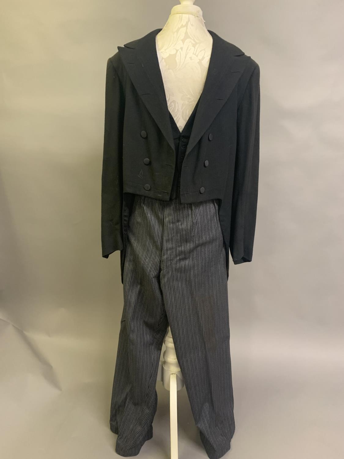 A gentleman’s vintage 3-piece morning suit with striped trousers and waistcoat, fairly large size