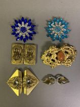Four elaborate belt buckles, three in gold base metal, one with diamanté, the largest in Art Nouveau