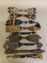 Nine miser’s purses, in a range of weights and designs, mostly beaded: four with geometric designs