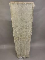 A 1920’s azute or assuit shawl, cream with silver metal decoration, fairly heavy, with a regular