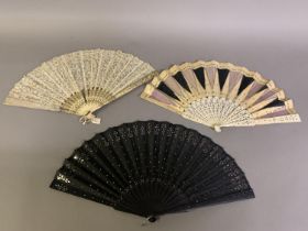 First quarter 20th century, two bone fans; the first with carved, shaped and pierced sticks, lightly