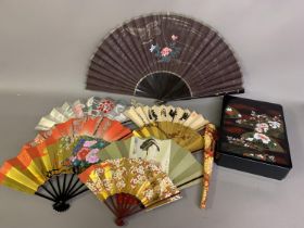 Japan: A sturdy fan box lacquered in black, the outer lid decorated with colourful designs of floral