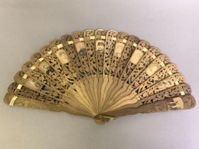 An unusual carved and pierced wood brisé fan, the detailed carving of flowers, each stick, including