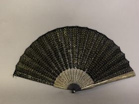 A very eye-catching sequin fan, early 20th century, the black gauze leaf completely covered with