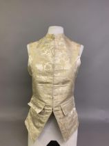 A gentleman’s cream woven silk waistcoat, the silk designed with flowers and a trompe l’oeil ribbon,