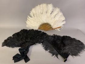 Feathers! Three ostrich feather fans, one black one cream, the cream on a man-made substance