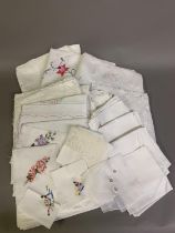 A quantity of bed and table linens from the same vendor, some unused, comprising