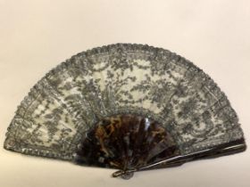 Chantilly Lace: a late 19th c black handmade lace fan, the design of roses and leaves, mounted à l’