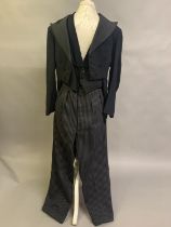 A gentleman’s vintage 3-piece morning suit with striped trousers and waistcoat, short jacket with