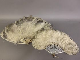 Two feather fans with mother-of-pearl montures, the first fairly large, the mother of pearl in pink,