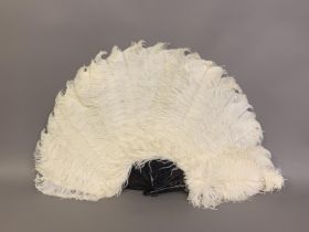 A large and showy white ostrich feather fan, the monture of tortoiseshell with good mottling,