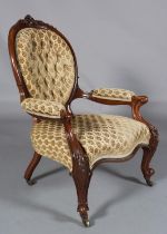 A VICTORIAN MAHOGANY ARMCHAIR having an encircling frame with foliate and harebell cresting,