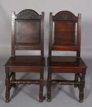 A PAIR OF 17TH CENTURY SINGLE CHAIRS, the arched top rail carved with leafage above a field panel