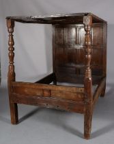 A 17TH CENTURY OAK FOUR POSTER BED WITH PANELLED CANOPY AND BACK, the foot board with baluster