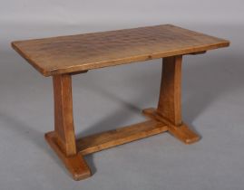 AN ADZED OAK REFECTORY OCCASIONAL TABLE, rectangular, the panel standards joined by a platform