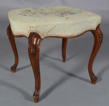 A VICTORIAN MAHOGANY DRESSING STOOL, having floral needlework upholstery, moulded serpentine seat