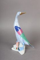 A HEREND PORCELAIN FIGURE OF A DUCK WITH FISH ON ROCKS, hand painted in blue and coral scale, dark