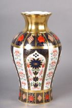 A ROYAL CROWN DERBY vase of Imari pattern 1128, having a panelled baluster body, gilt neck with