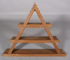 A SET OF OAK WALL SHELVES of triangular form, with gouge cut decoration and three shelves, 111cm