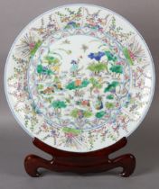 A CHINESE FAMILLE ROSE CHARGER, painted to the centre with water fowl amongst lily pads with a