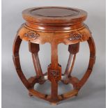 A CHINESE HARDWOOD JARDINIERE STAND with a circular indented top upon lobed legs, having carved