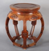 A CHINESE HARDWOOD JARDINIERE STAND with a circular indented top upon lobed legs, having carved