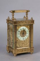 A LATE 19TH CENTURY GILDED BRASS CARRIAGE CLOCK the face applied with trailing flower filigree and