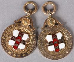 TWO VICTORIAN CYCLIST MEDALS IN 9CT GOLD AND ENAMEL, both awarded to A. C. Hick in 1897 by the