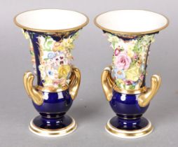 A PAIR OF BLOOR DERBY COBALT BLUE VASES c.1820’s encrusted with flowers having twin gilt handles,