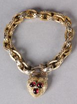 A VICTORIAN BRACELET IN 9CT GOLD, pierced and engraved trace links, fastened with a heart shaped,