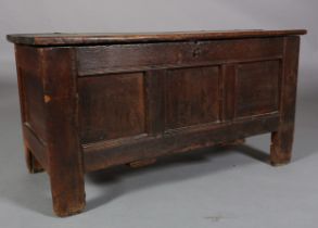 AN EARLY 18TH CENTURY OAK JOINED CHEST, having a planked top above a triple indented panel front,